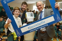 PRESS RELEASE... NO REPRODUCTION FEE..RISE OF THE MACHINES: Minister for Education, Richard Bruton T.D. and Stevie the Robot, a high tech prototype robot designed to work in assisted care facilities visited the students of Gaelscoil Cholmcille in Coolock, Dublin 17 today.  To coincide with the visit, the parents committee erected three billboards outside their to raise awareness of their longstanding campaign for a permanent school building. (More info: Laura Robertson 087 12 12 500)Pictured today : Minister for Education, Richard Bruton T.D. with Stevie The Robot, Cian Foley and Dr.Conor McGinn during a visit to Gaelscoil Cholmcille in CoolockPIC : Lorraine O'Sullivan/Sharppix